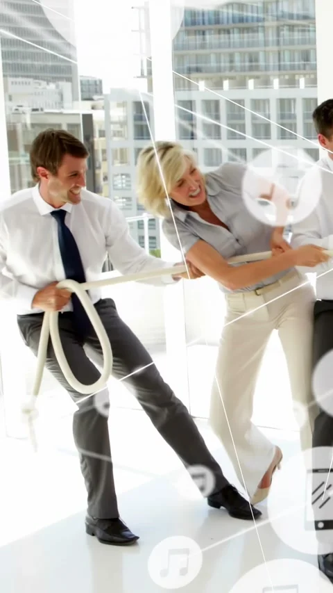 Vertical video: Grabbing rope man bracing and woman pulling in office for team Stock Footage 334381830