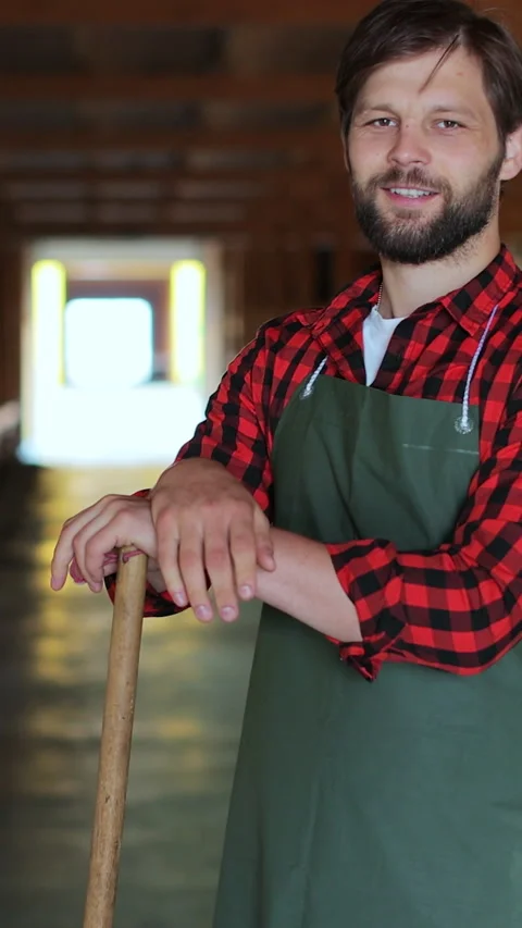 Vertical video. Green Apron Man: Goat Husbandry Sustainable Farming. Stock Footage 344630174