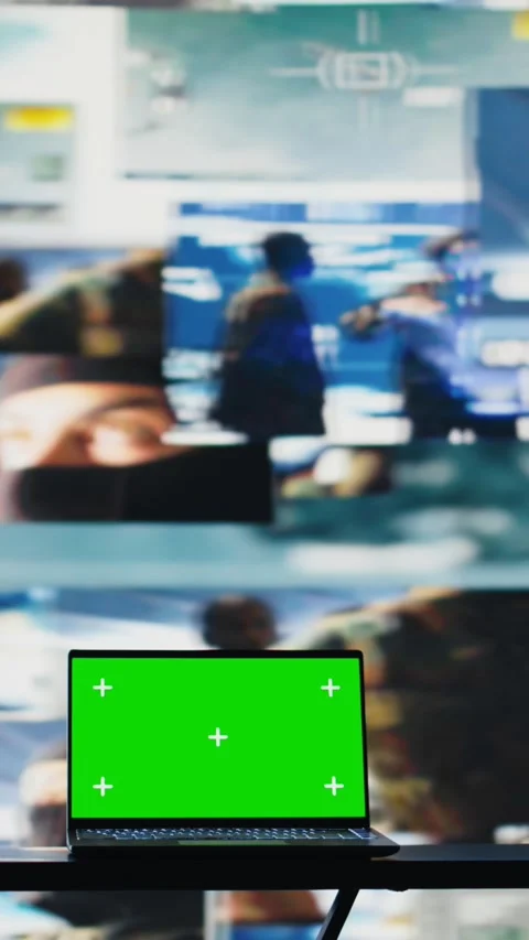 Vertical Video Green screen on laptop next to military satellite imagery of Stock Footage 310914334