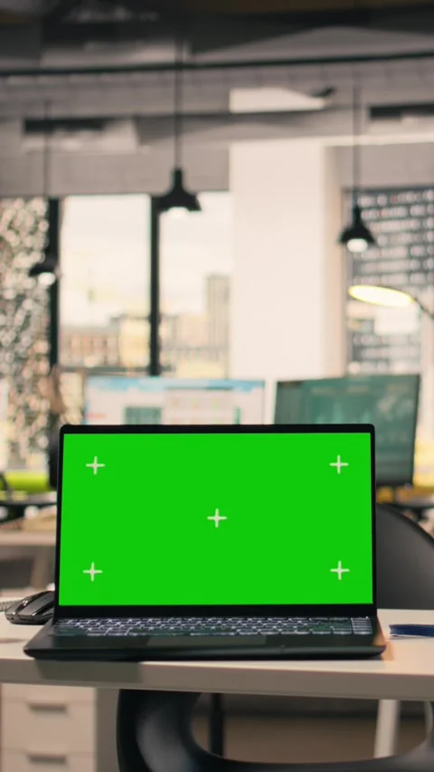 Vertical Video Green screen laptop at workstation in empty bright open office Stock Footage 329319104