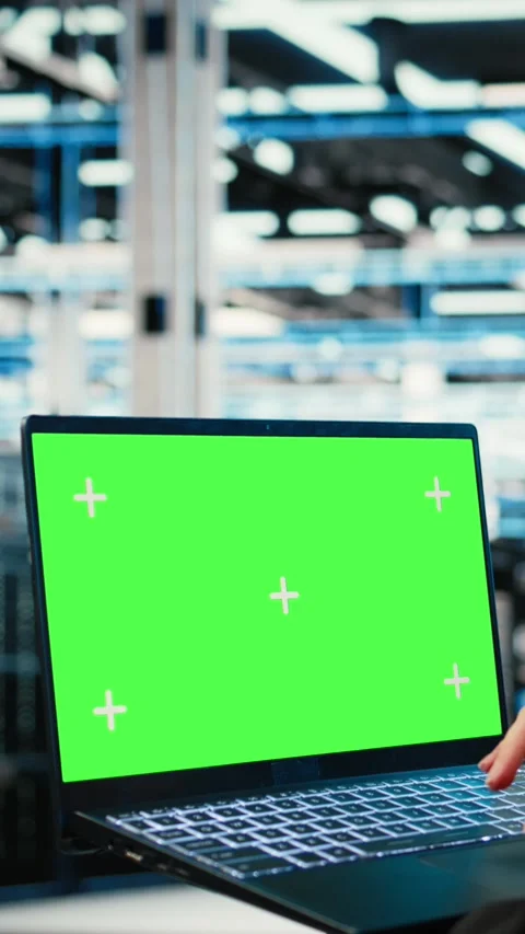 Vertical video Green screen laptop used by data center developer to monitor Stock Footage 329320975