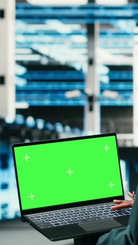 Vertical video Green screen laptop in data center and AR tech used by technician Stock Footage 329713413