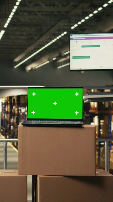 Vertical Video Green screen laptop display in industrial warehouse storage Stock Footage 330138726
