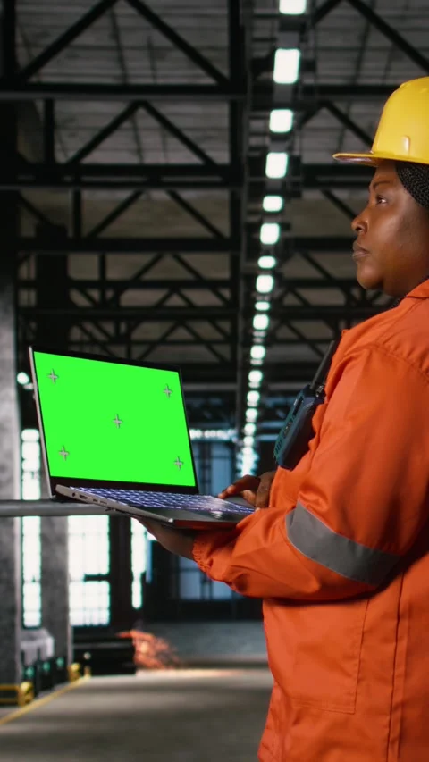 Vertical Video Green screen laptop held by black woman engineer in industrial Stock Footage 330139362