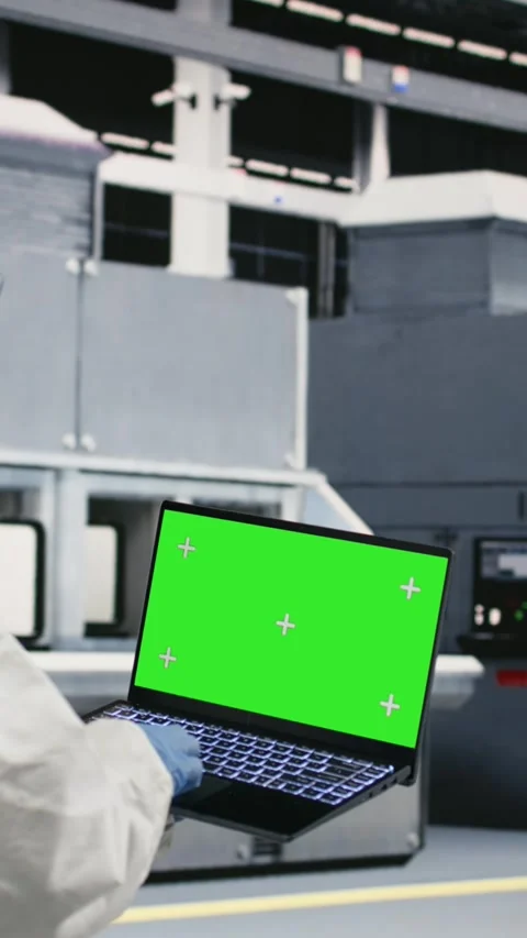 Vertical video Green screen laptop used by cleanroom technician tracking Stock Footage 333614698