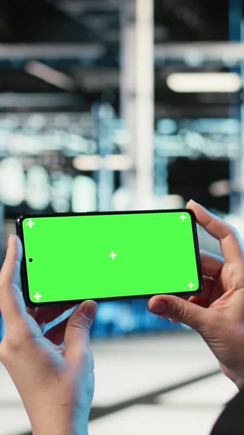 Vertical video Green screen mockup smartphone used by server hub worker watching Stock Footage 329316490
