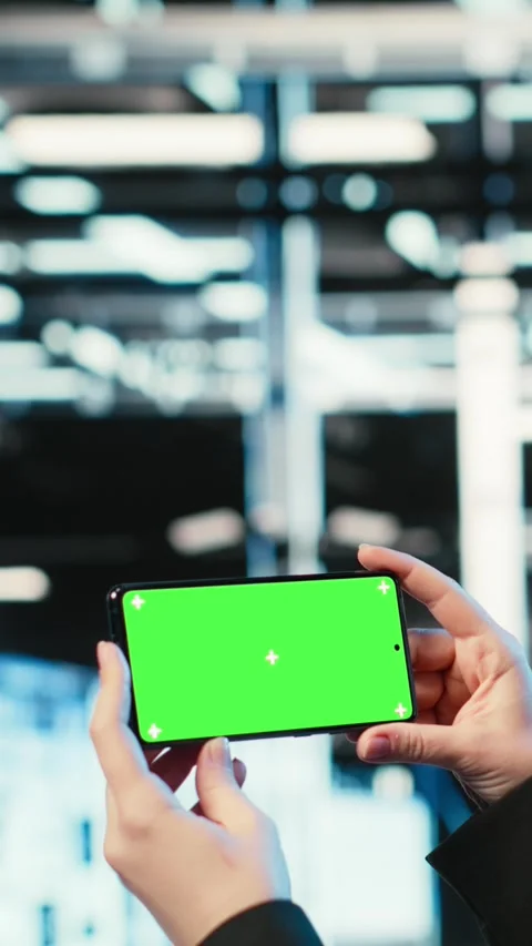 Vertical video Green screen mockup smartphone used by server hub worker watching Stock Footage 330097679