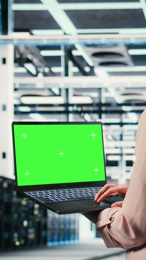 Vertical video Green screen mockup laptop, machines and worker in server hub Stock Footage 330139463