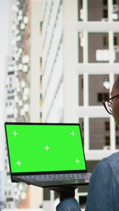 Vertical Video Green screen mockup laptop used by black woman walking, composing Stock Footage 334198735