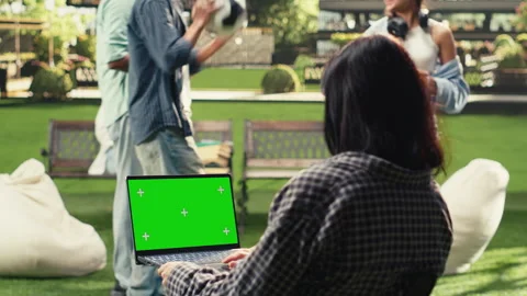 Vertical Video Green screen mockup on laptop as student uses trackpad on Stock Footage 340800343