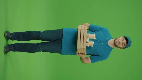 Vertical Video Green Screen Portrait food delivery man holding pizza and coffee Stock Footage 263384312