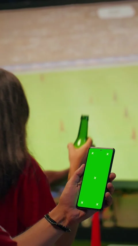 Vertical video Green screen smartphone mockup used by man viewing soccer match Stock Footage 346784208