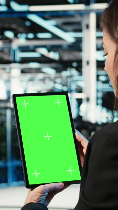 Vertical video Green screen tablet used by data center admin to optimize server Stock Footage 328330346
