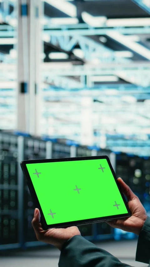 Vertical video Green screen tablet in data center and augmented reality used by Stock Footage 329649966
