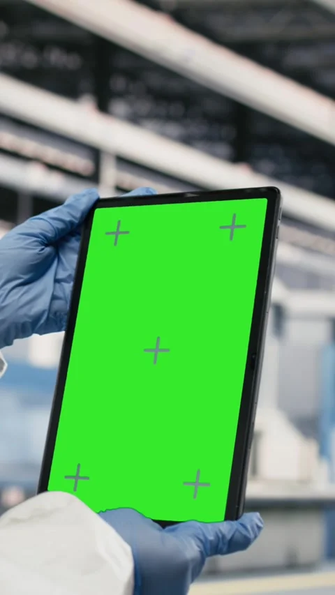 Vertical video Green screen tablet used by QC engineer to monitor microchip Stock Footage 333614689