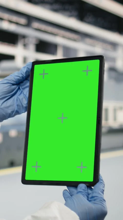 Vertical video Green screen tablet used by QC engineer to monitor microchip Stock Footage 333615097