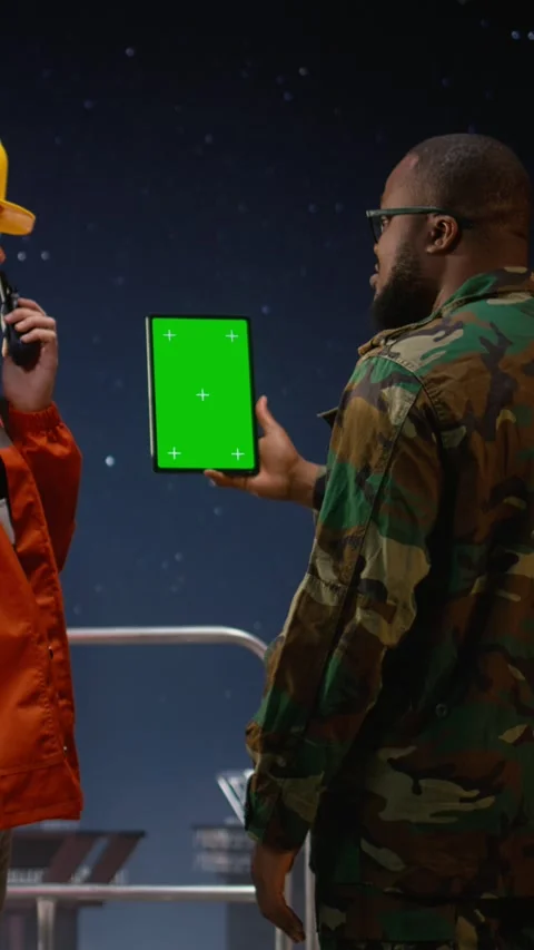 Vertical video Green screen tablet used by military man on drilling rig with Stock Footage 339888237