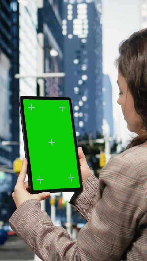 Vertical video Green screen tablet used by businesswoman on urban street, close Stock Footage 343558431