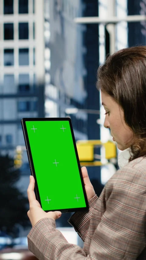 Vertical video Green screen tablet used by businesswoman on urban street, close Stock Footage 343560064