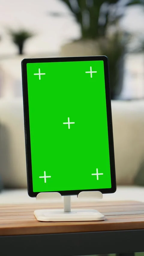 Vertical video Green screen tablet on rooftop table with leafy plants, close up Stock Footage 345166210