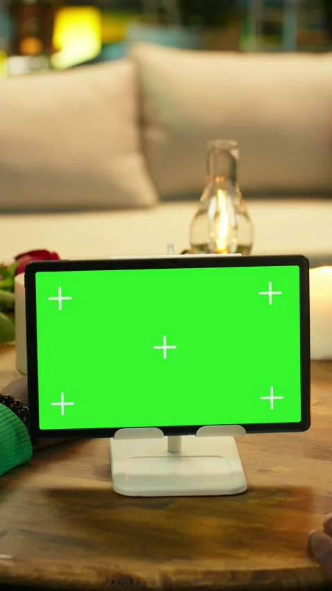 Vertical video Green screen tablet used by couple during candlelit rooftop date Stock Footage 347085998