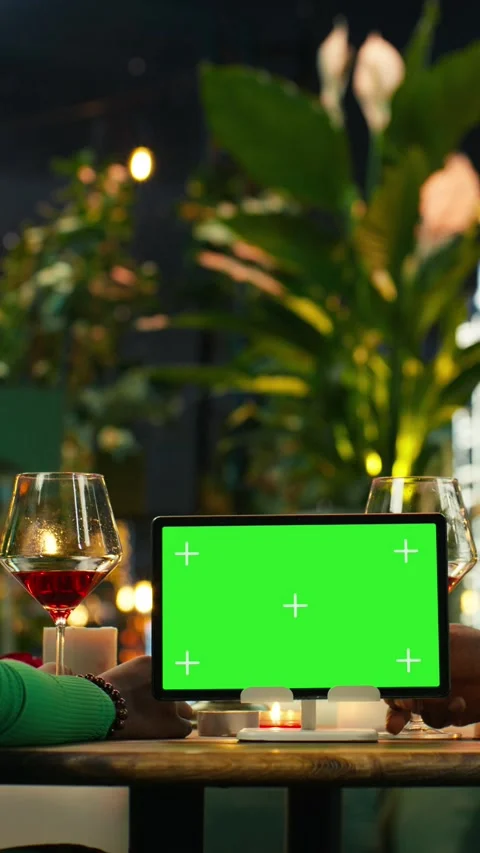 Vertical video Green screen tablet used by boyfriend and girlfriend while they Stock Footage 347086074
