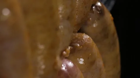 Vertical video. Grilled grill with pork sausages on a black background. Video stock 220104870