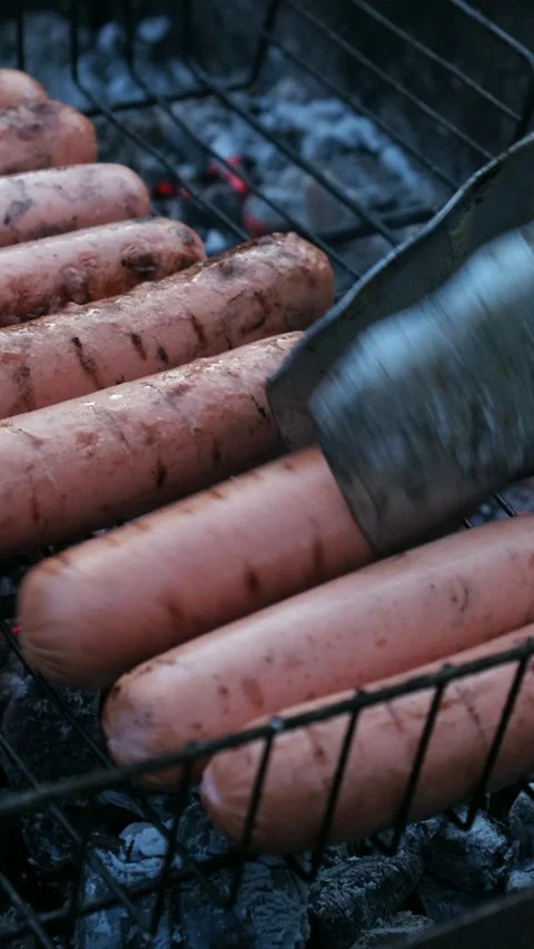 Vertical video. Grilling sausages during summer picnic Stock Footage 340333686