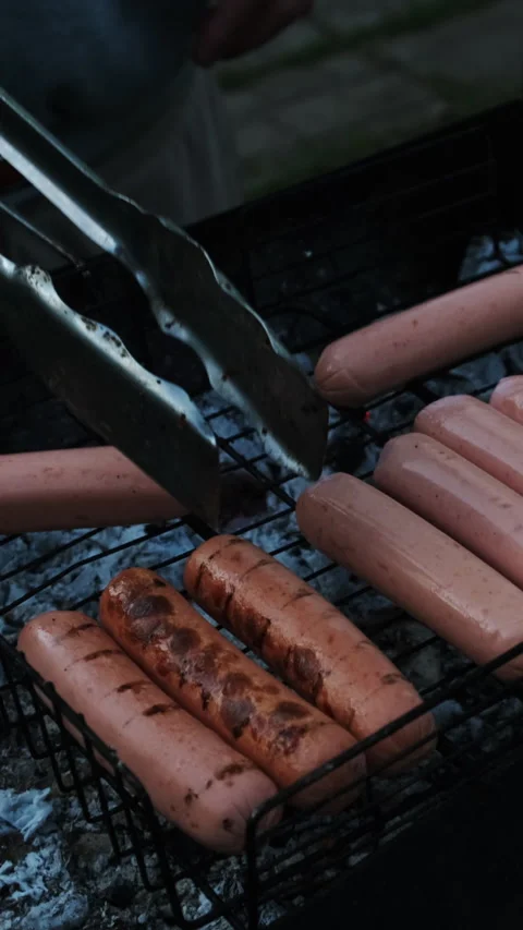 Vertical video. Grilling sausages during summer picnic Stock Footage 340333690