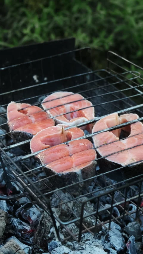 Vertical video. Grilling steaks of salmon fish during summer weekend Stock Footage 340333698