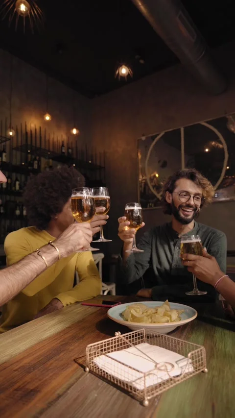 Vertical video of a Group of colleague workers toast with beer in the restaurant Stock Footage 224337400