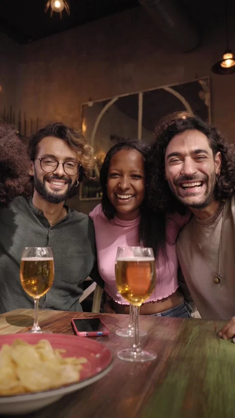 Vertical video group of friends looking at camera in a restaurant bar after work Stock Footage 224345664