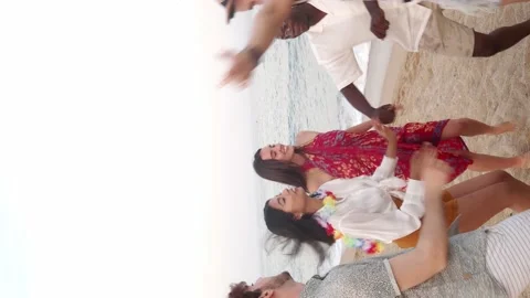 Vertical video of a group of multiethnic young people dancing on the beach Stock Footage 197110377