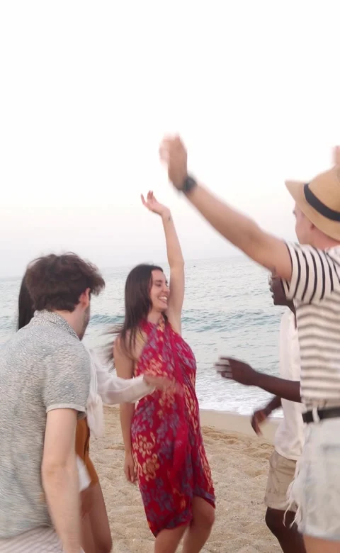 Vertical video. group of multiethnic young people dancing on the beach Stock Footage 231250007