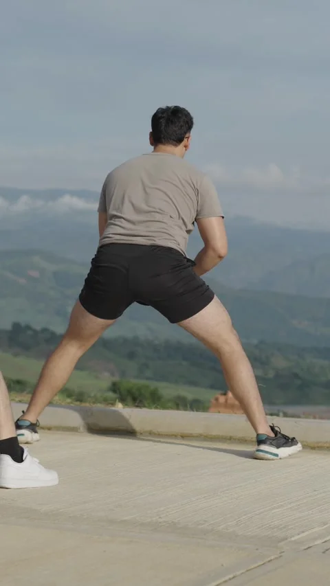 Vertical video of a group of young adults stretching and warming up. Stock Footage 282797129