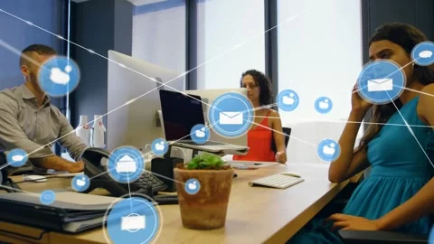 Vertical video: Growing blue icons over office table, urging woman in teal dress Stock Footage 332281693