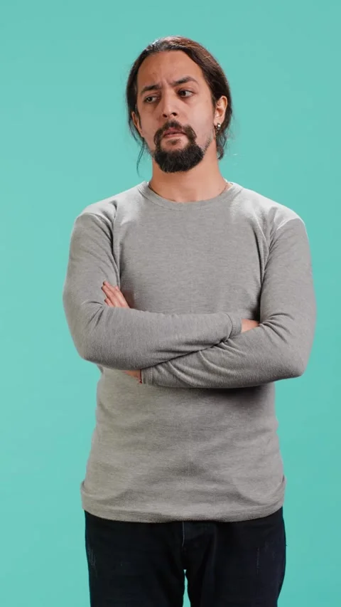 Vertical video Grumpy man crossing arms, feeling upset by events Stock Footage 314516453