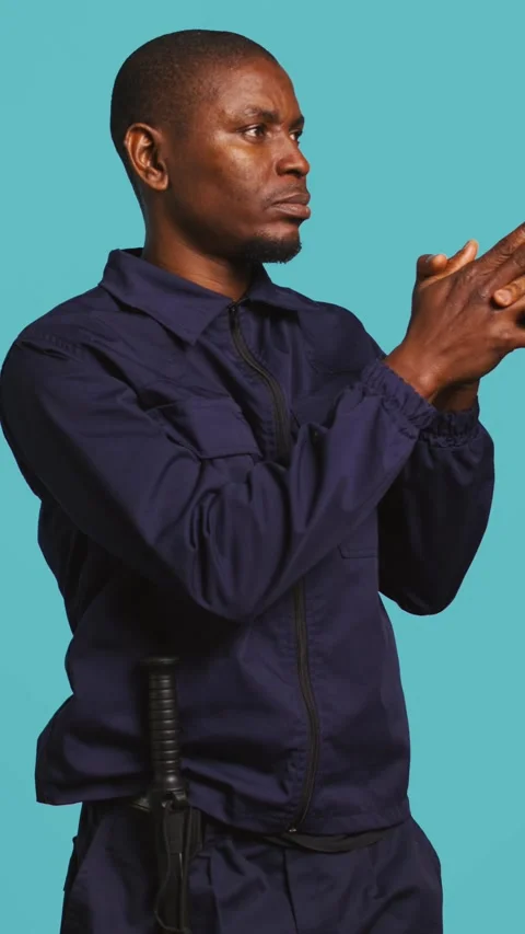 Vertical video Guardian prepared to handle security breaches, doing pistol Stock Footage 277425703