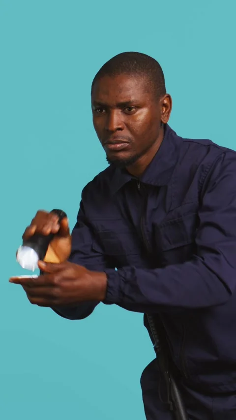 Vertical video Guardian prepared to handle security breaches, doing pistol Stock Footage 277425895