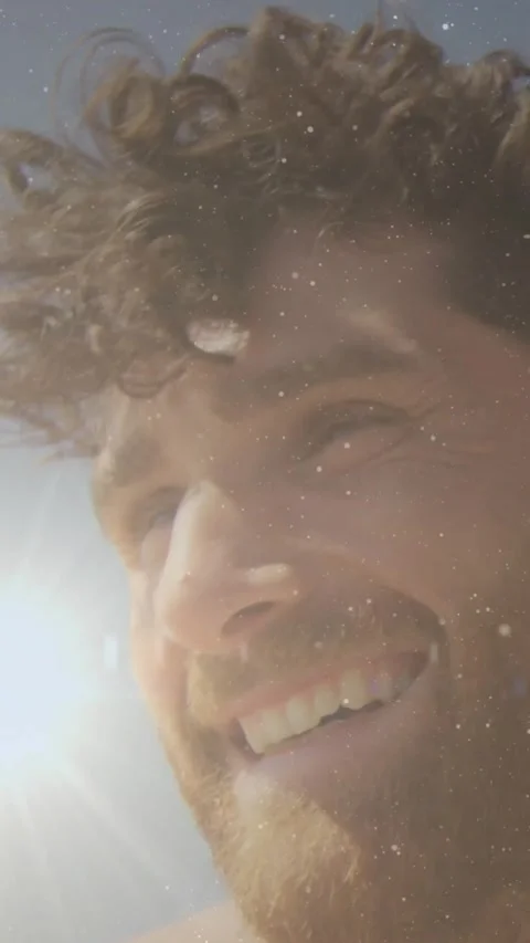 Vertical video: Guy starting selfie for content, moving closer, laughing, lens Stock Footage 332335580