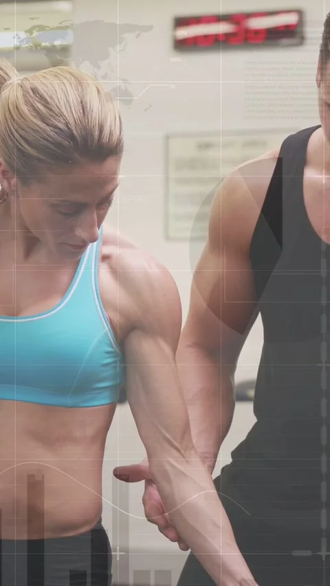 Vertical video: Gym lifter looking down curling, trainer spotting forearm Stock Footage 333496066