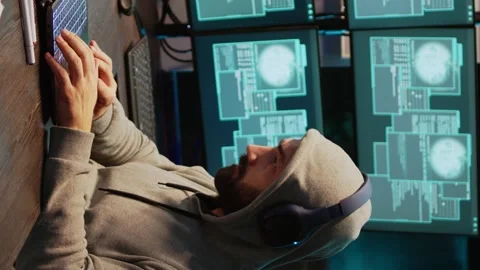 Vertical video: Hacker coder hacking system at night using virus 動画素材 221656385