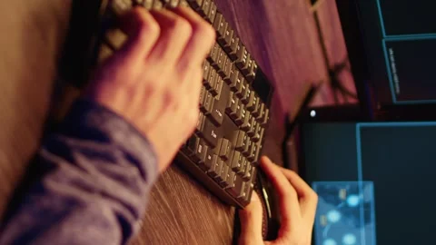 Vertical video Hacker typing malware code on keyboard 库存影片 255251602