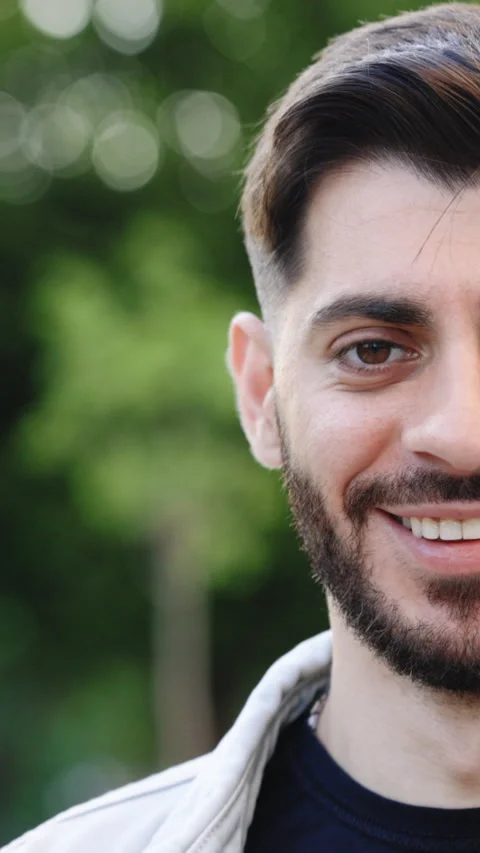 Vertical Video of Half face of bearded man with beautiful brown eye while Stock Footage 305864575