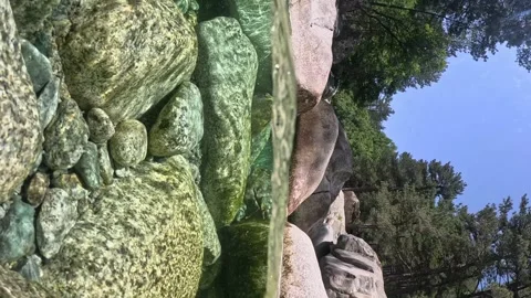 VERTICAL VIDEO, Half underwater slow motion shot of fast mountain stream with Stock Footage 252284259