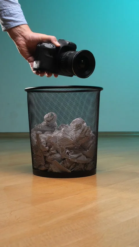 Vertical video hand discarding an obsolete digital single lens reflex camera Stock Footage 342760654