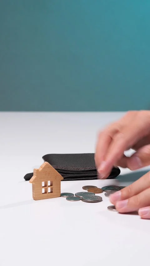 Vertical video hand holding an empty wallet with a small wooden house model and Stock Footage 342766203