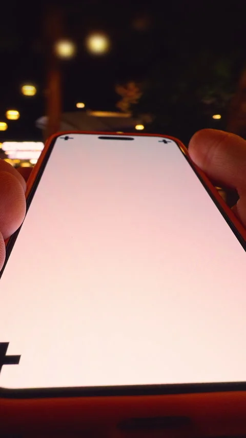 Vertical video. Hand Holding Smartphone with Corner Tracking Marks at Night as Stock Footage 320722968