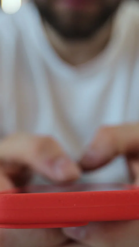 Vertical video. Hand of man using texting mobile phone or chat in home. Concept Stock Footage 347778491