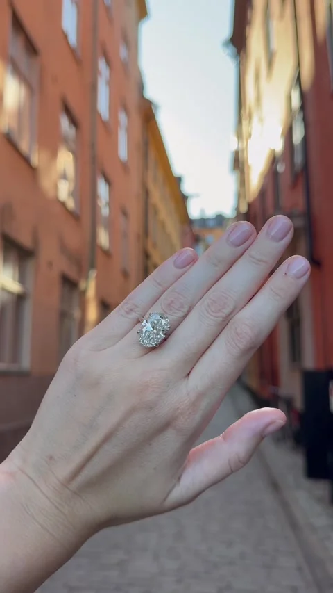 Vertical video of hand with oval diamond wedding band in warm evening light Video stock 316902176